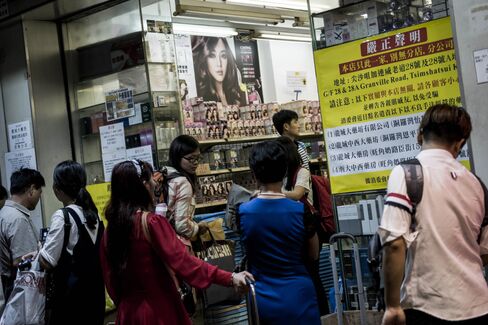 A banner warning customers of copycat branches is displayed at the "original" Dragon City Pharmacy.