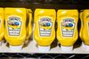 Berkshire Hathaway branded bottled of Kraft Heinz Co. Yellow Mustard are displayed during a shareholders shopping day ahead of the Berkshire Hathaway Inc. annual meeting in Omaha, Nebraska, U.S., on Friday, May 4, 2018. Berkshire Hathaway Inc. investors should get ready for a bumpy ride. Warren Buffett's company is scheduled to report earnings Saturday morning before its annual meeting, and a new accounting rule could sink results.