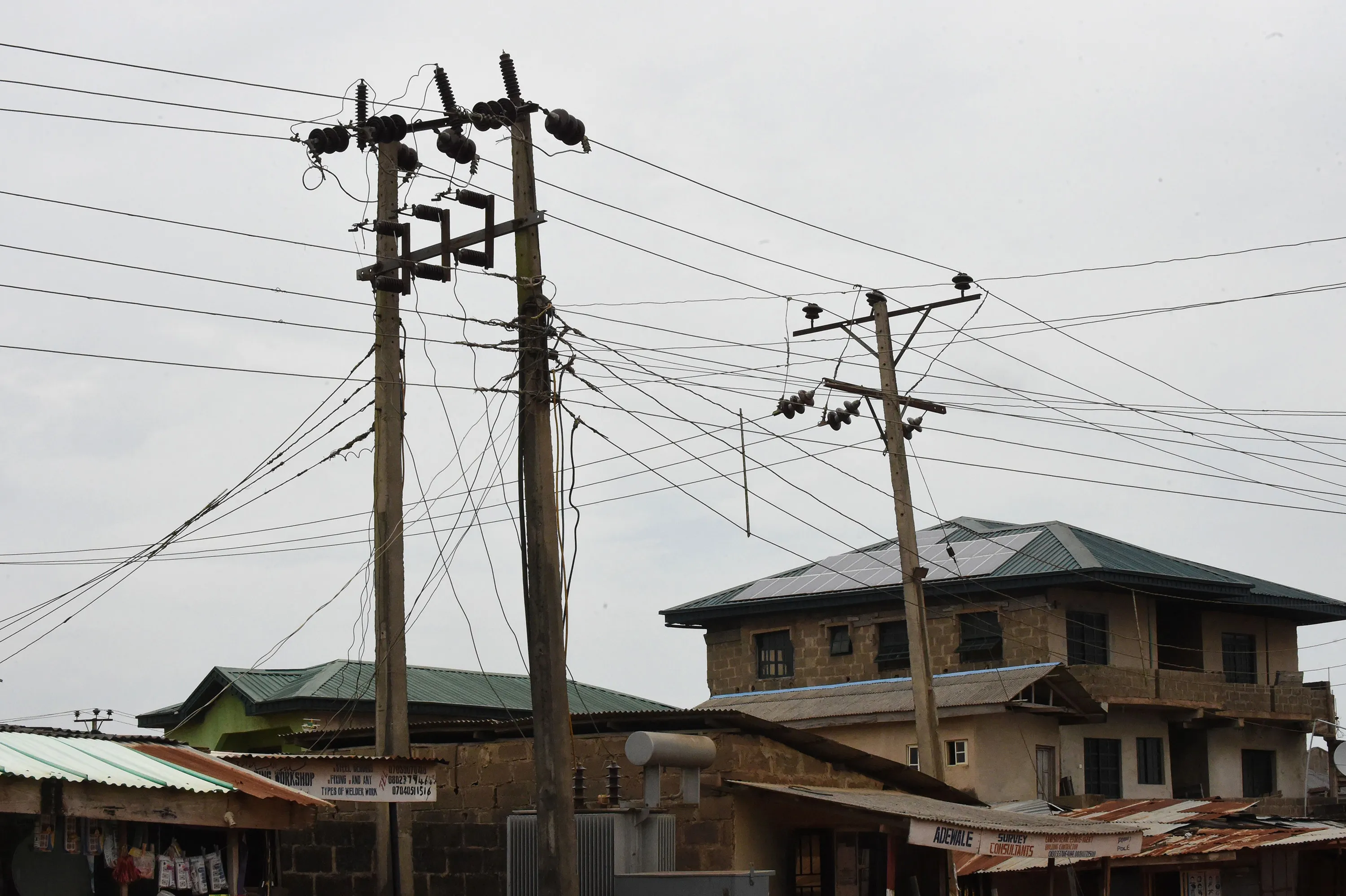 Public power cables and transformers stand across solar panels mounted on the roof top of a building&nbsp;in Lagos.