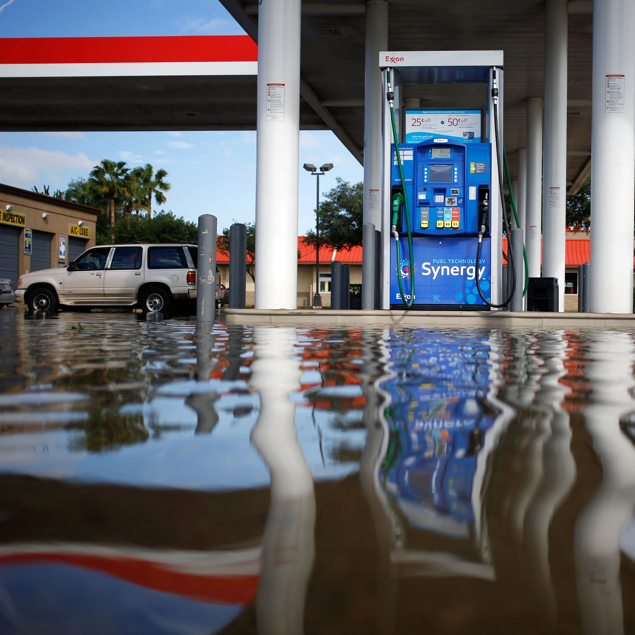 Floodwaters from Hurricane Harvey surround a fuel pump at an Exxon Mobil Corp. gas station in Houston, Texas, U.S., on Wednesday, Aug. 30, 2017. Unprecedented flooding from the Category 4 storm that slammed into the state's coast last week, sending gasoline prices surging as oil refineries shut, may also set a record for rainfall in the contiguous U.S., the weather service said Tuesday.
