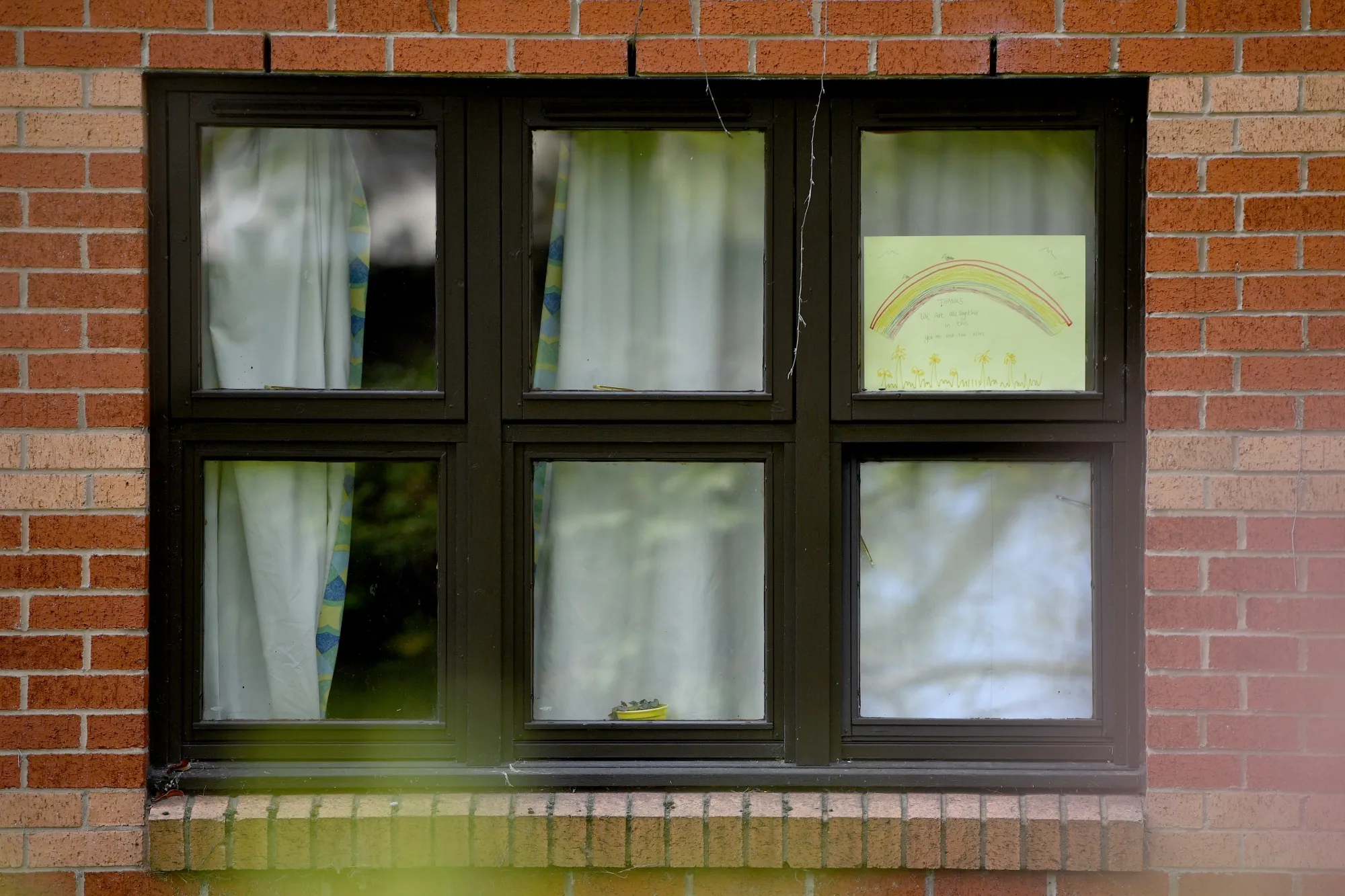 A rainbow poster, used as a symbol of hope during the coronavirus pandemic, is seen in the window of a care home in Manchester on&nbsp;on April 15, 2020.&nbsp;