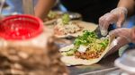 Employees prepare lunch orders at a Chipotle Mexican Grill restaurant.
