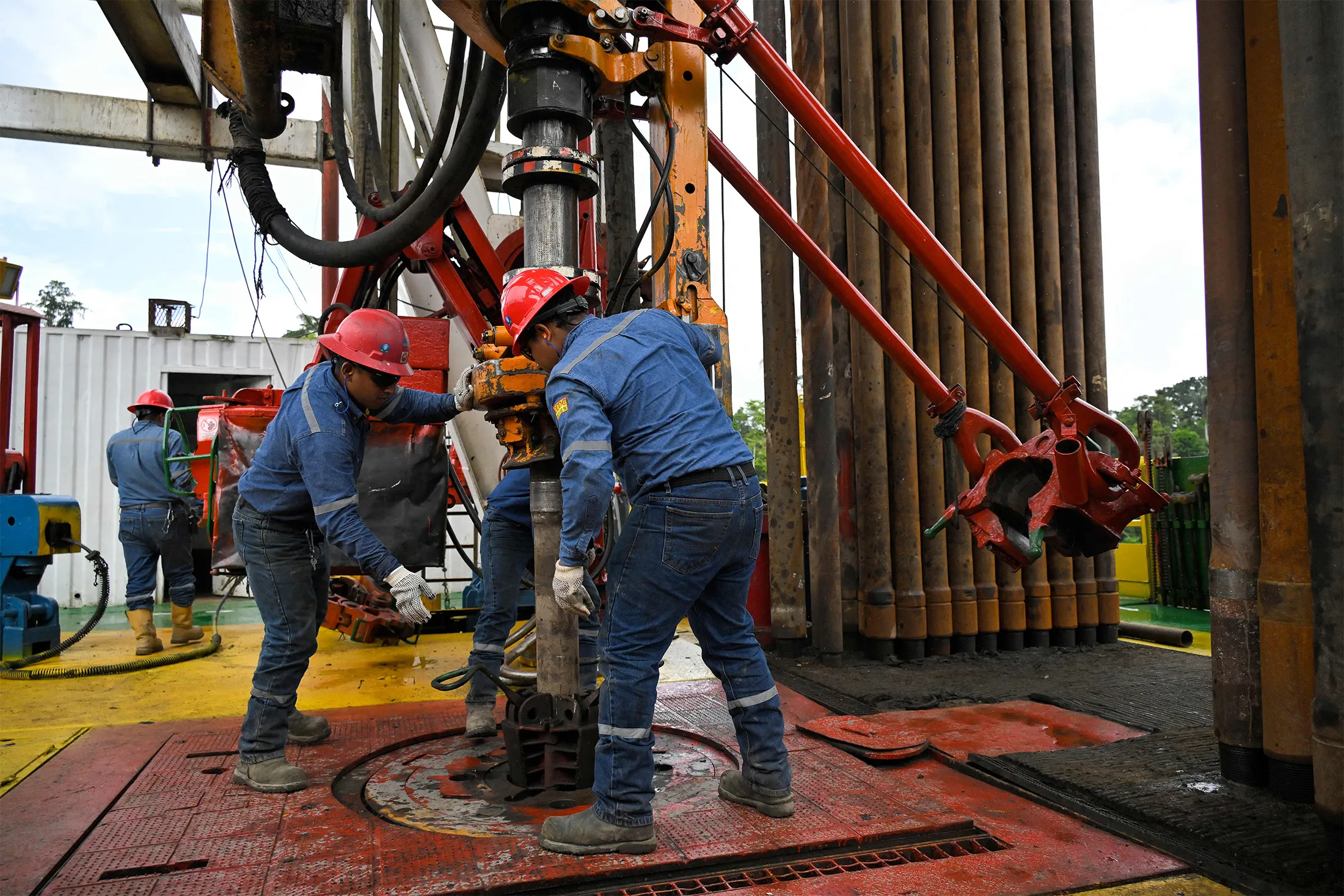 Petroecuador workers at an oil well in the Ishpingo field in Yasuni National Park, in Ecuador, on June 21, 2023.