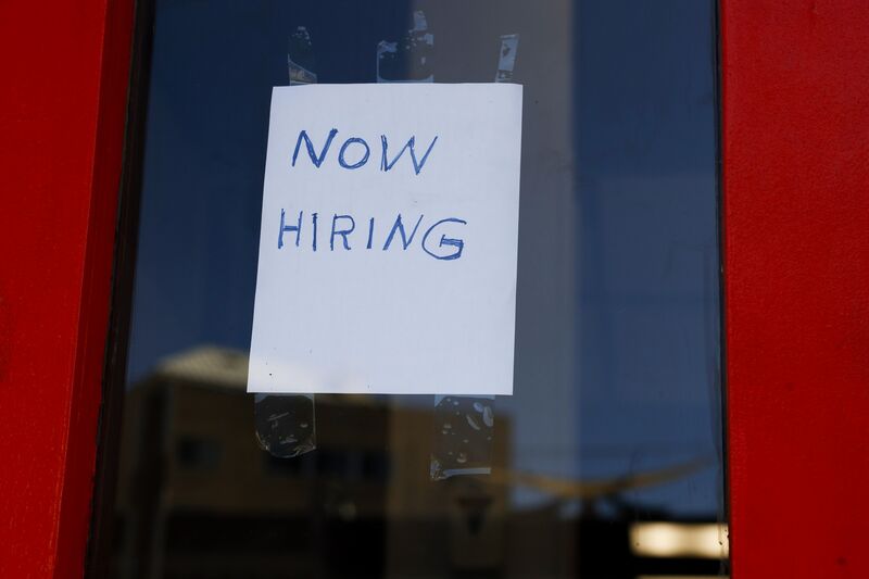 WASHINGTON, DC - OCTOBER 07: A "Now Hiring" sign is displayed on a storefront in Adams Morgan Neighborhood on October 07, 2022 in Washington, DC. 