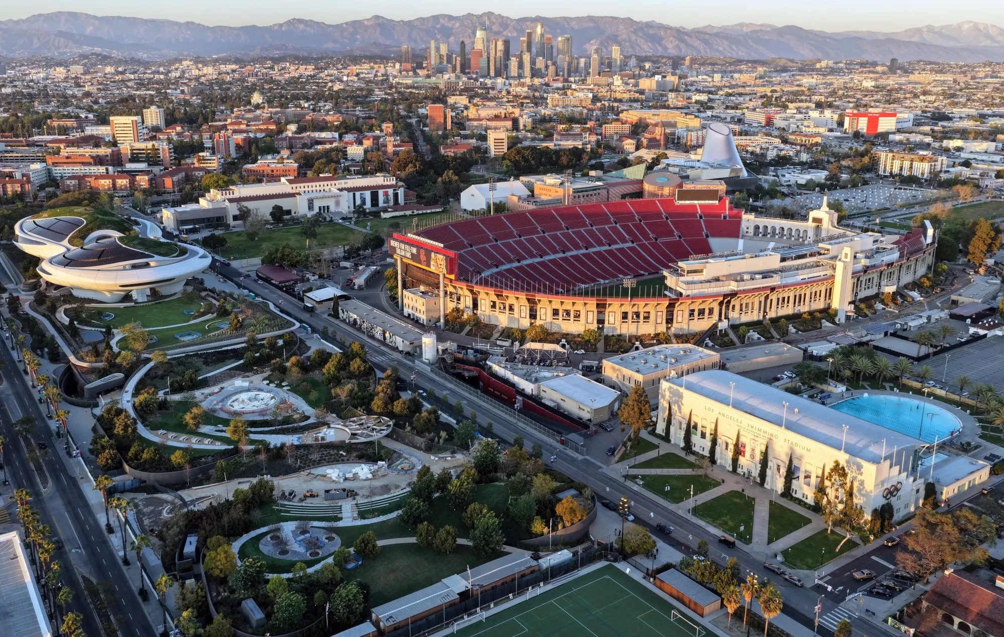 The Los Angeles Memorial Coliseum, right, and the under-construction Lucas Museum of Narrative Art, left, in Exposition Park in March.