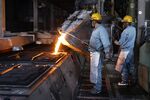 A worker pours molten iron into a sand mold during production of utility hole covers at a factory in Otawara, Tochigi Prefecture, Japan. Photographer: Kiyoshi Ota/Bloomberg