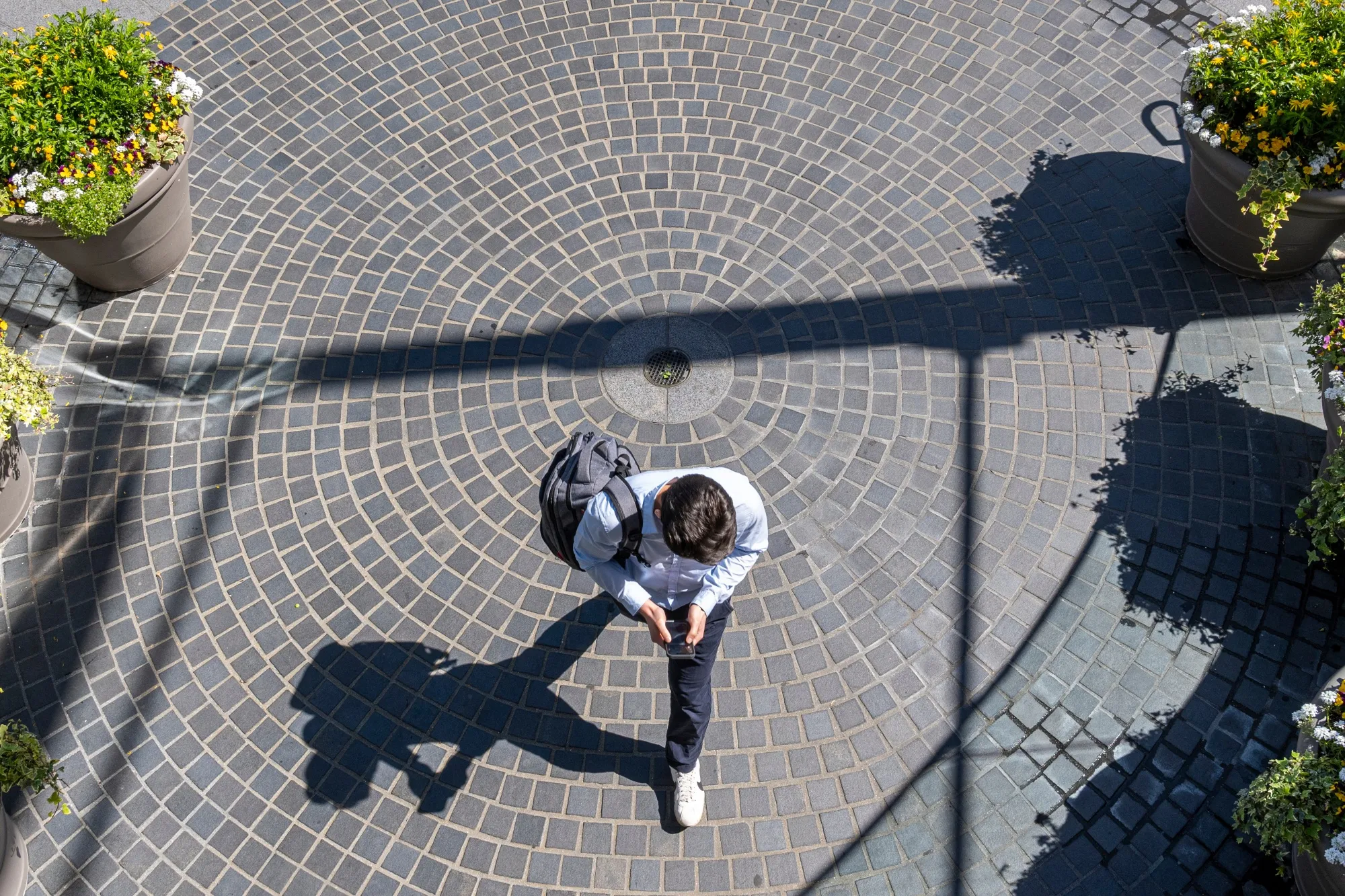 A pedestrian walks towards The Embarcadero Center in San Francisco, California.