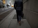 A pedestrian walks along a street near the New York Stock Exchange.