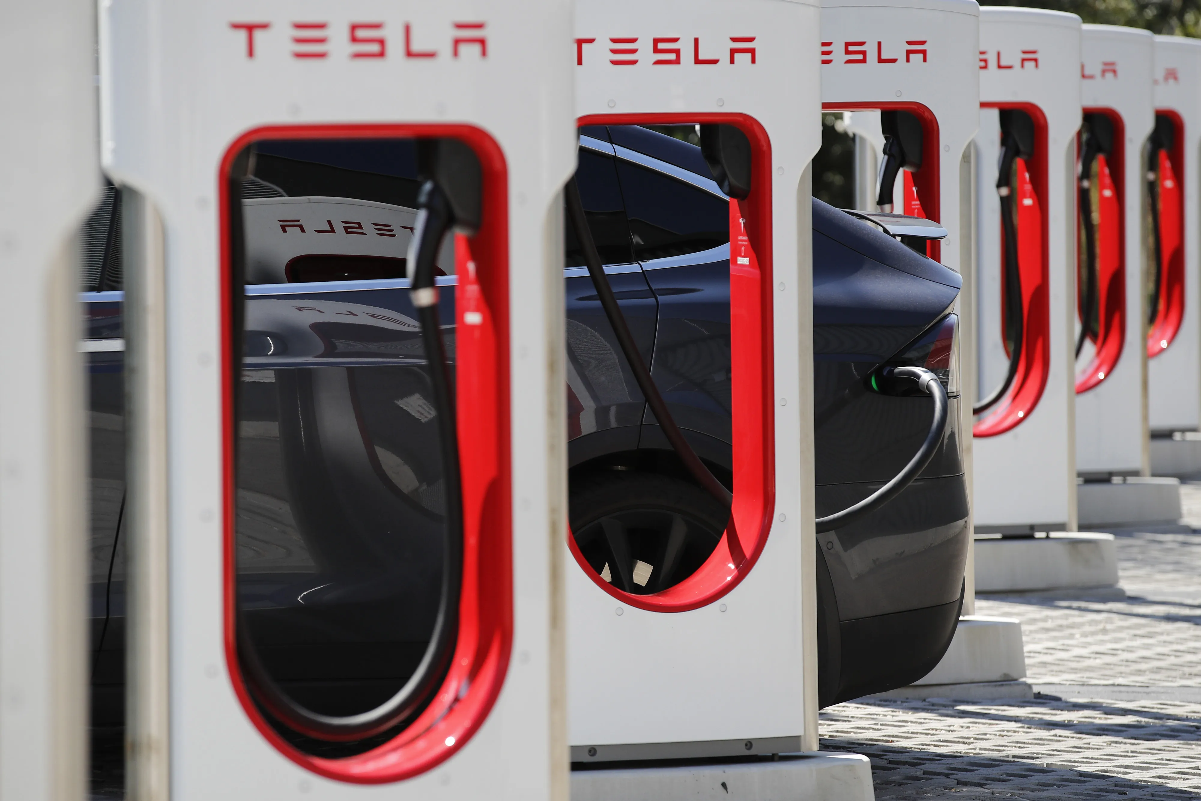 A Tesla Inc. Model S electric vehicle charges at a Supercharger station.