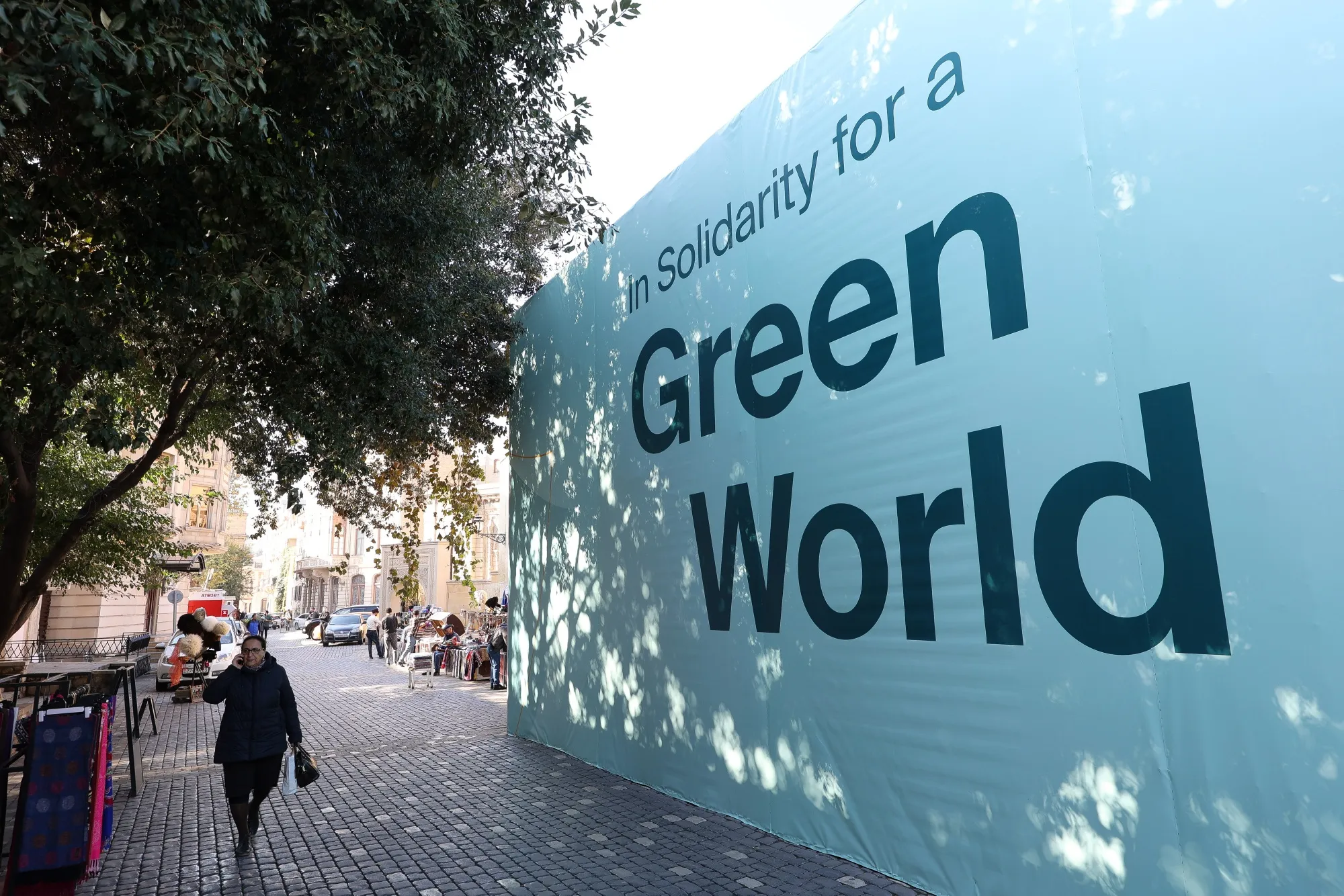 An "In Solidarity For a Green World" banner on a street during the COP29 climate conference, in Baku, Azerbaijan.