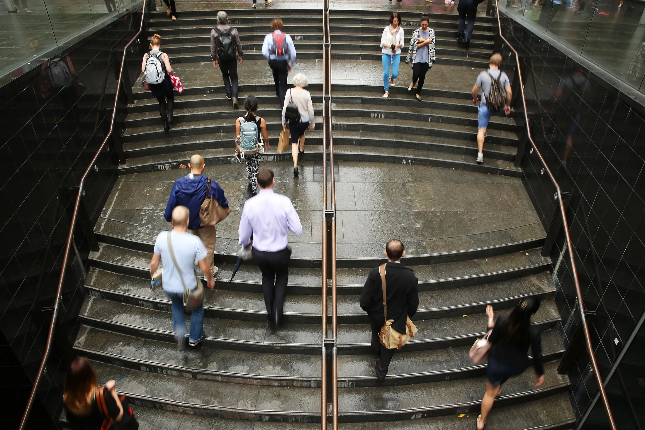 Commuters ascend a flight of stairs at Martin Place in the central business district of Sydney, Australia, on Monday, Feb. 10, 2014. Australian business confidence rose for the first time in 4 months, according to a National Australia Bank Ltd. report.
