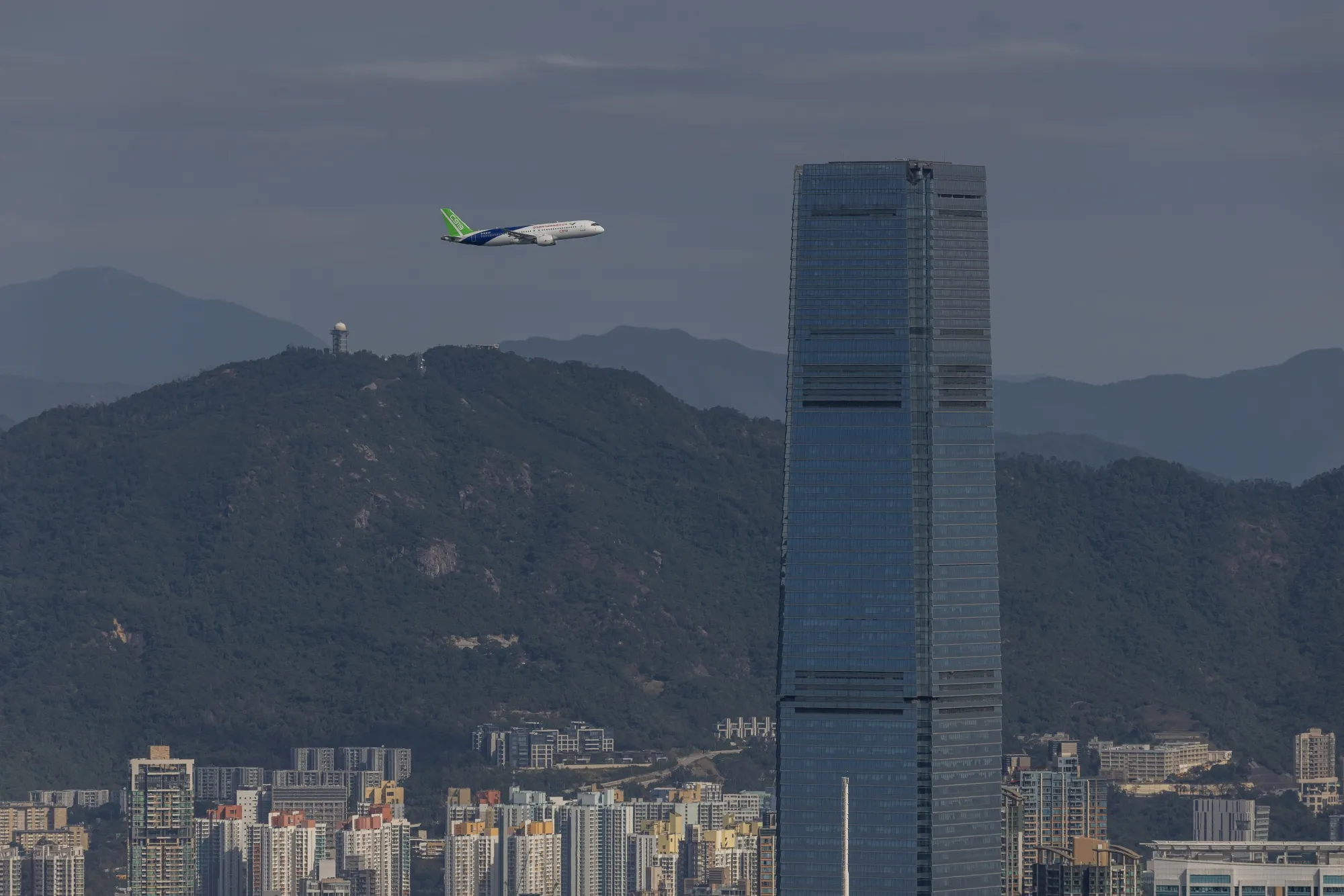 A Comac C919 aircraft flies over Victoria Harbour in Hong Kong on Dec. 16.
