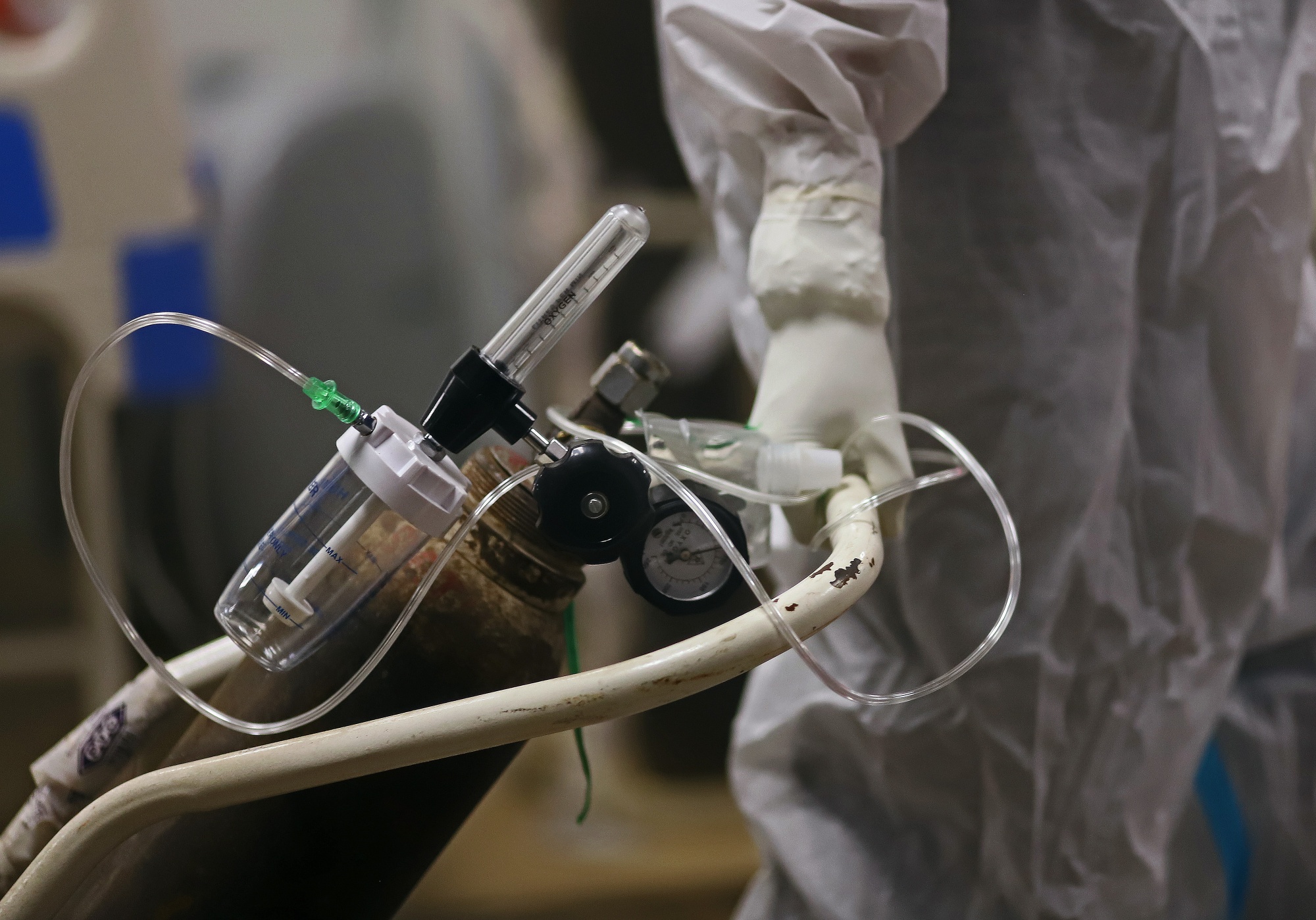 A health worker wheels an oxygen canister in a Covid-19 hospital set up inside a stadium in New Delhi on April 23.