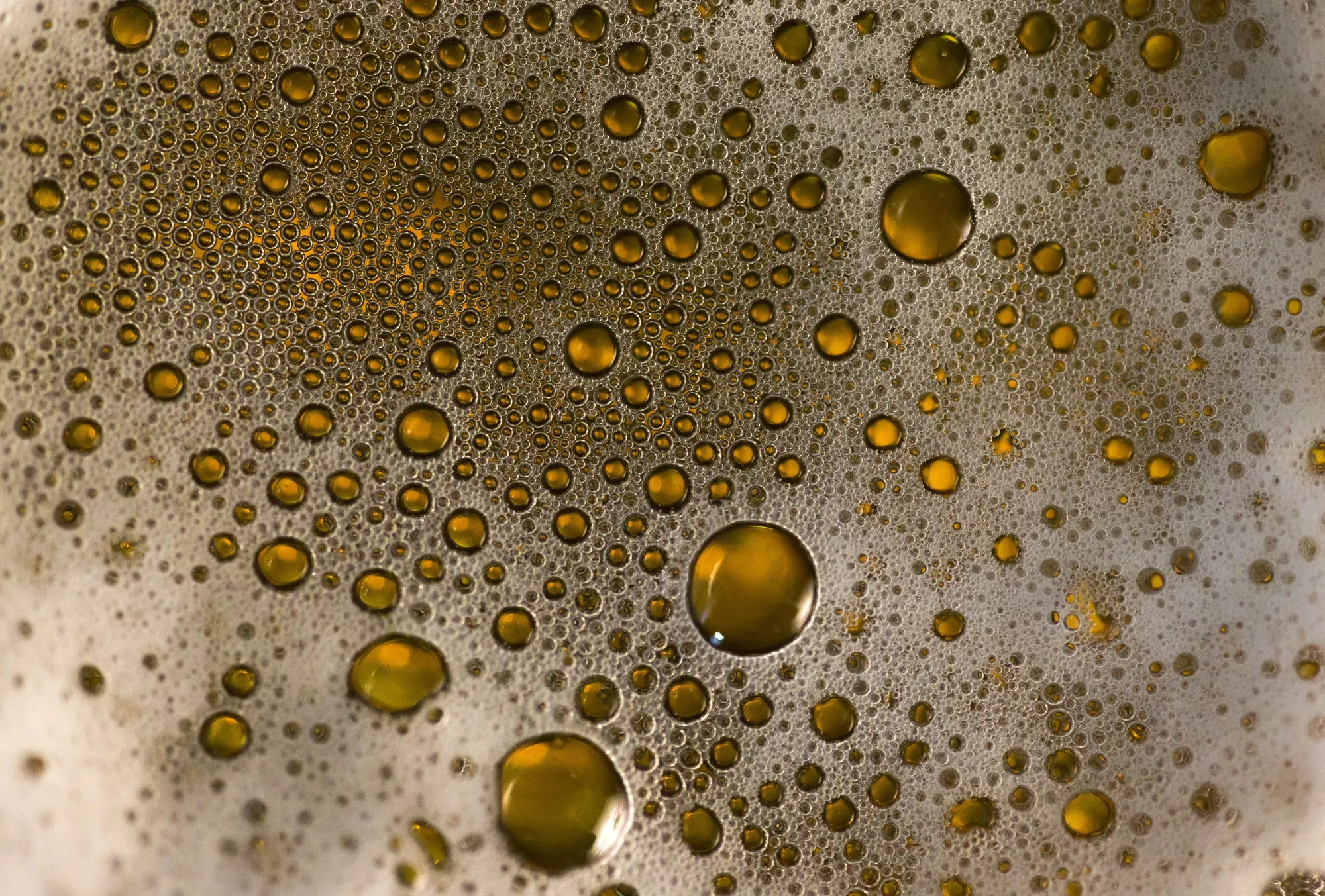 Droplets of Asahi Breweries Ltd.'s Asahi Super Dry beer sits on glass in this arranged photograph in Tokyo, Japan, on Tuesday, Dec. 13, 2016. Asahi agreed to buy SABMiller Plc's eastern European assets including Pilsner Urquell from Anheuser-Busch InBev NV for 7.3 billion euros ($7.8 billion), as the Budweiser maker ties up loose ends after combining the world's two biggest brewers.