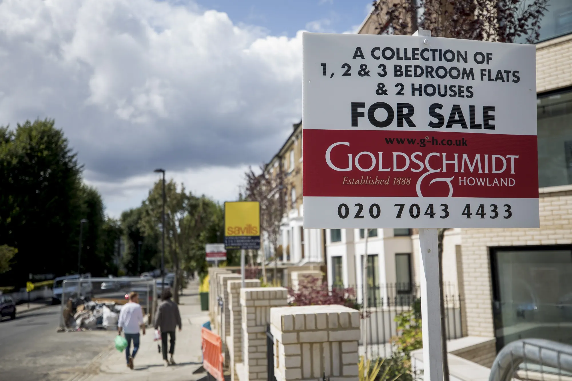 Sales boards outside residential properties in London, U.K.