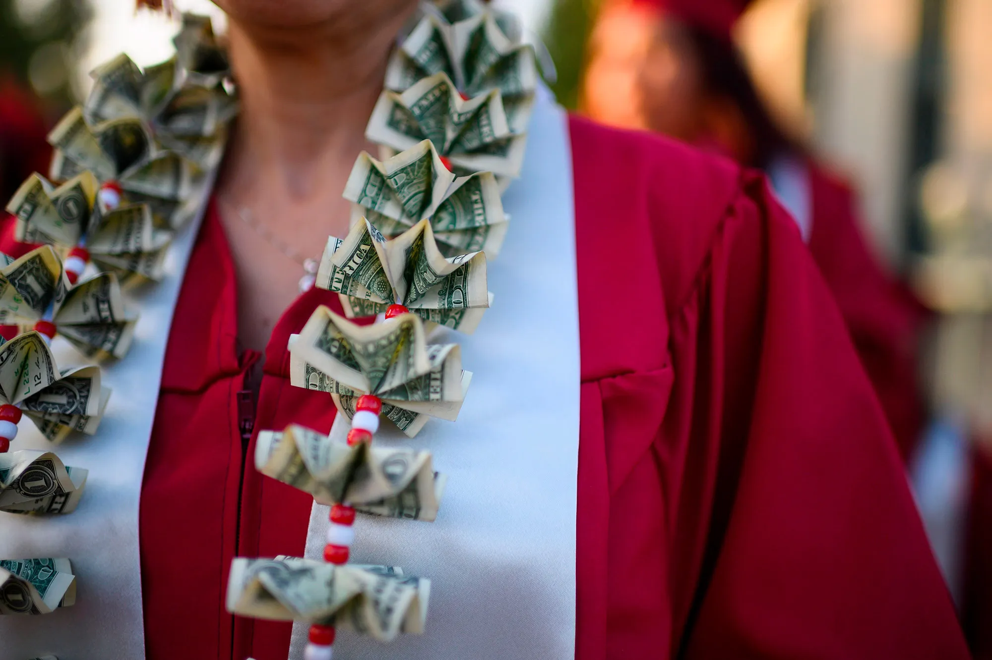 A graduating student wears a money lei, a necklace made of dollar bills, at a&nbsp;college graduation ceremony,&nbsp;in Pasadena, California.