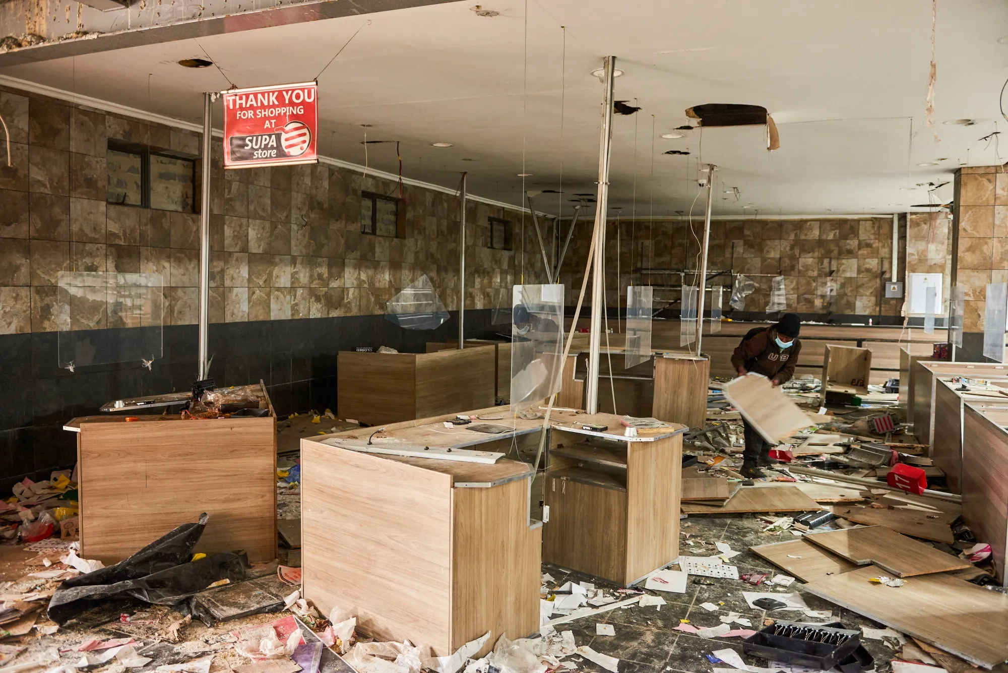 A resident clears debris from inside a&nbsp;supermarket following rioting in the Soweto district of Johannesburg, South Africa, on&nbsp;July 15.