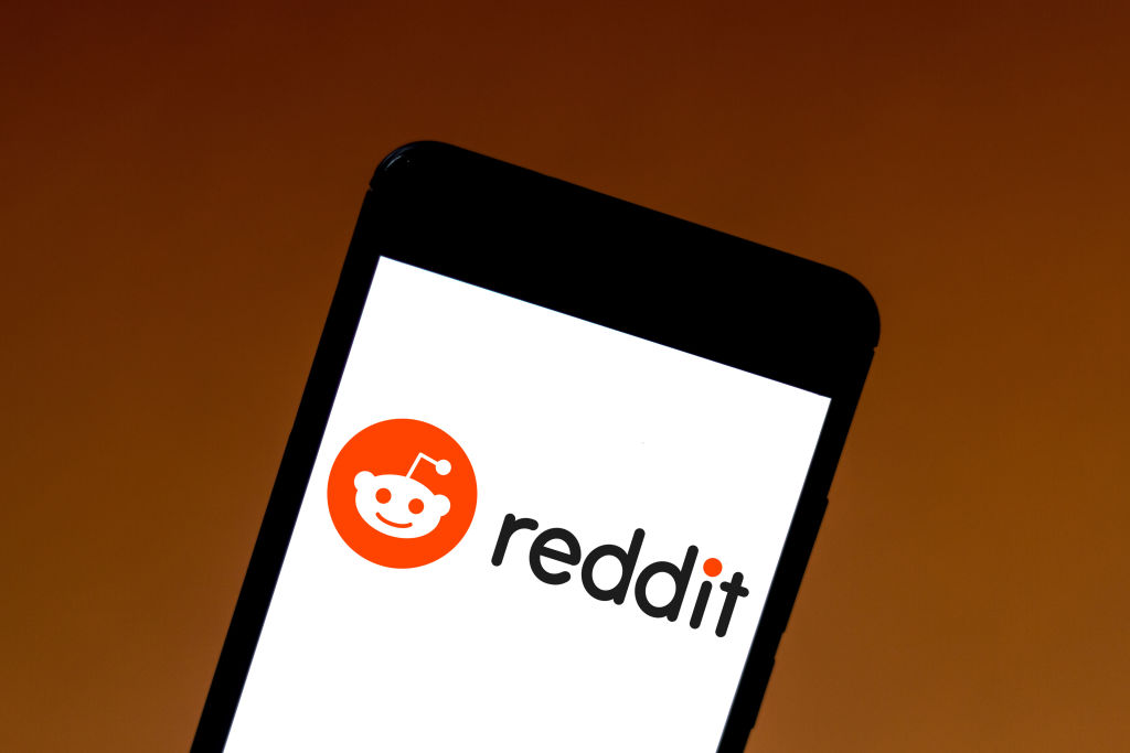 In this photo illustration the Reddit logo is seen displayed