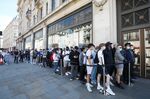 Customers stand in line to enter the Niketown store, operated by Nike Inc., in London, U.K.
