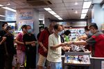 People line up to redeem consumption vouchers at a convenience store in Hong Kong on Aug. 1.