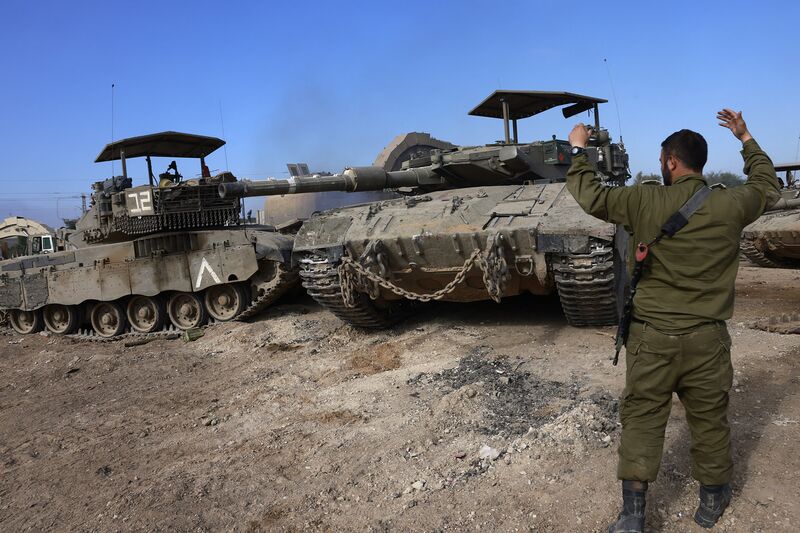 An Israeli soldier directs a tank near the border with the Gaza Strip in southern Israel on Dec. 25.