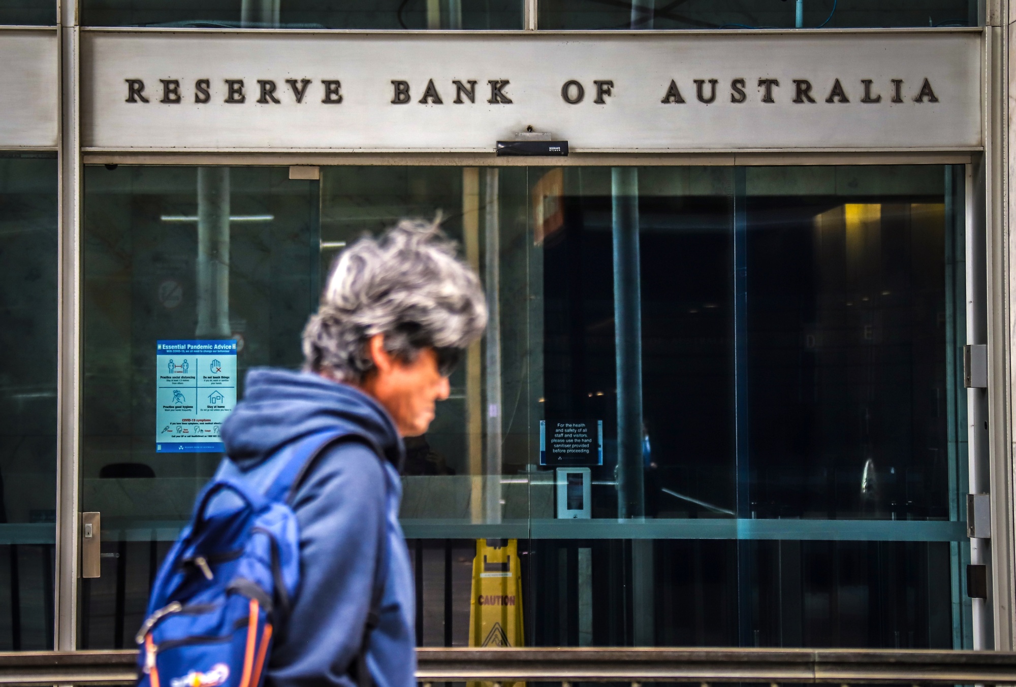 A pedestrian walks past an entrance to the closed Reserve Bank of Australia building&nbsp;in Sydney&nbsp;on May 18.