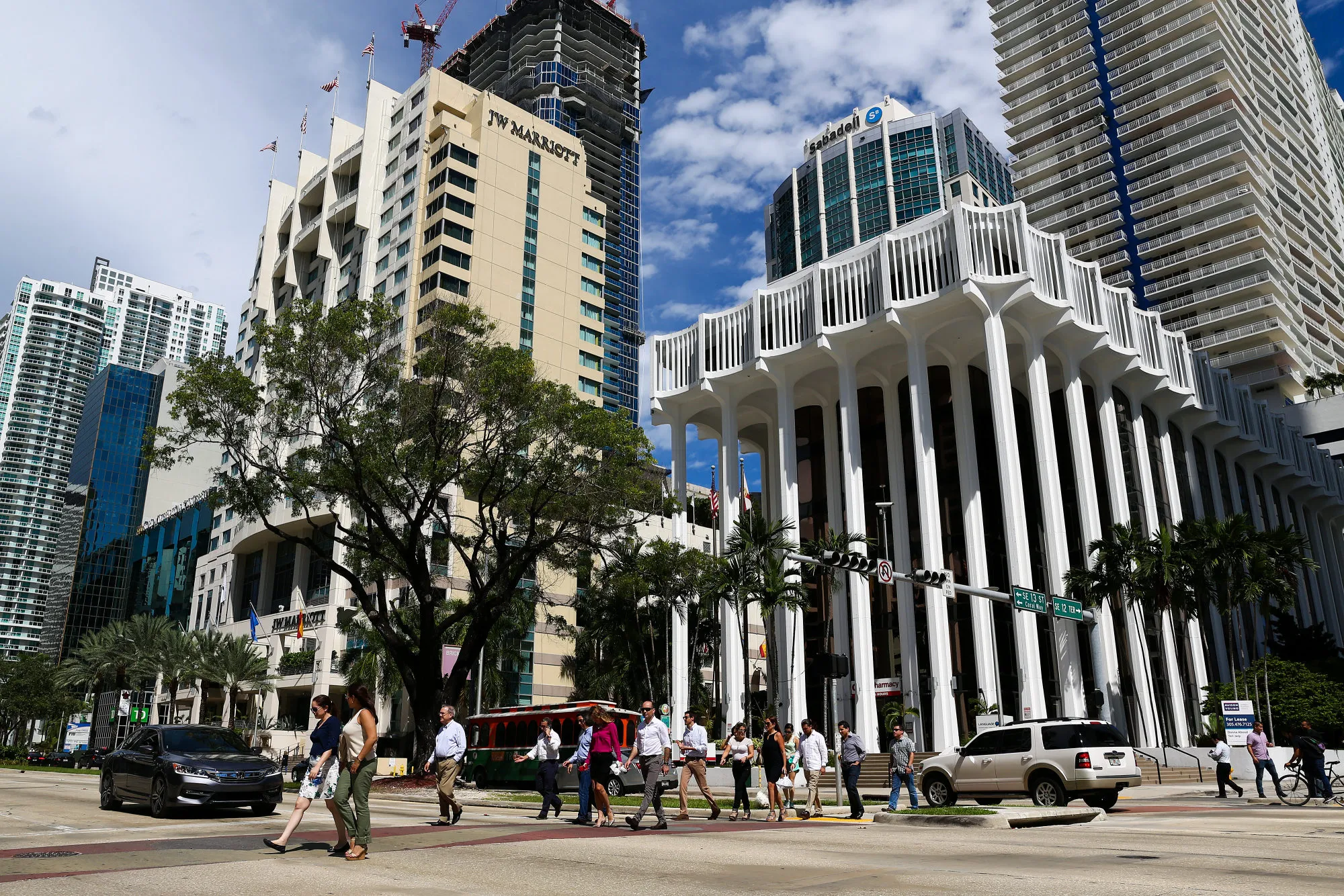 Pedestrians walk in front of high rise condominiums in&nbsp;Miami, Florida.
