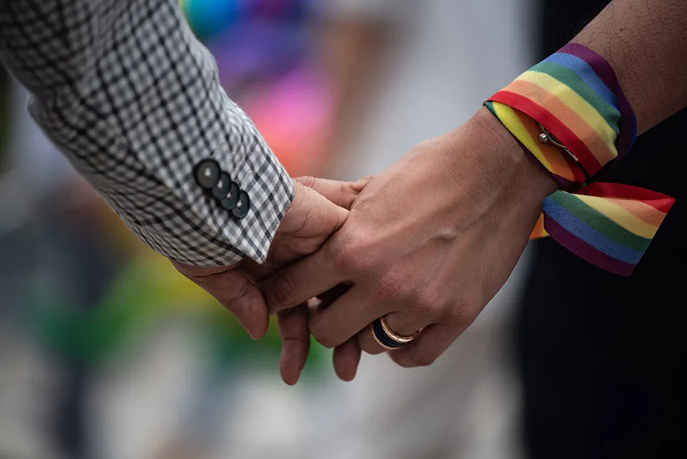 A same-sex couple hold hands during an event to raise awareness of gay rights in Hong Kong on May 25, 2019.&nbsp;