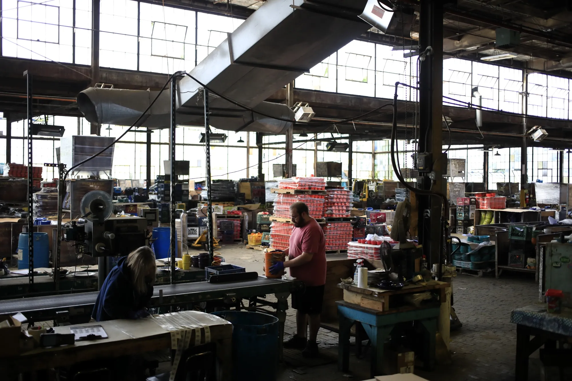 Workers prepare items for shipping inside a warehouse in Newell, West Virginia, US.