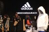 Customers browse goods inside an Adidas AG retail store in Herzogenaurach, Germany.