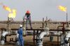 Iraqi labourers work at an oil refinery in the southern town Nasiriyah.