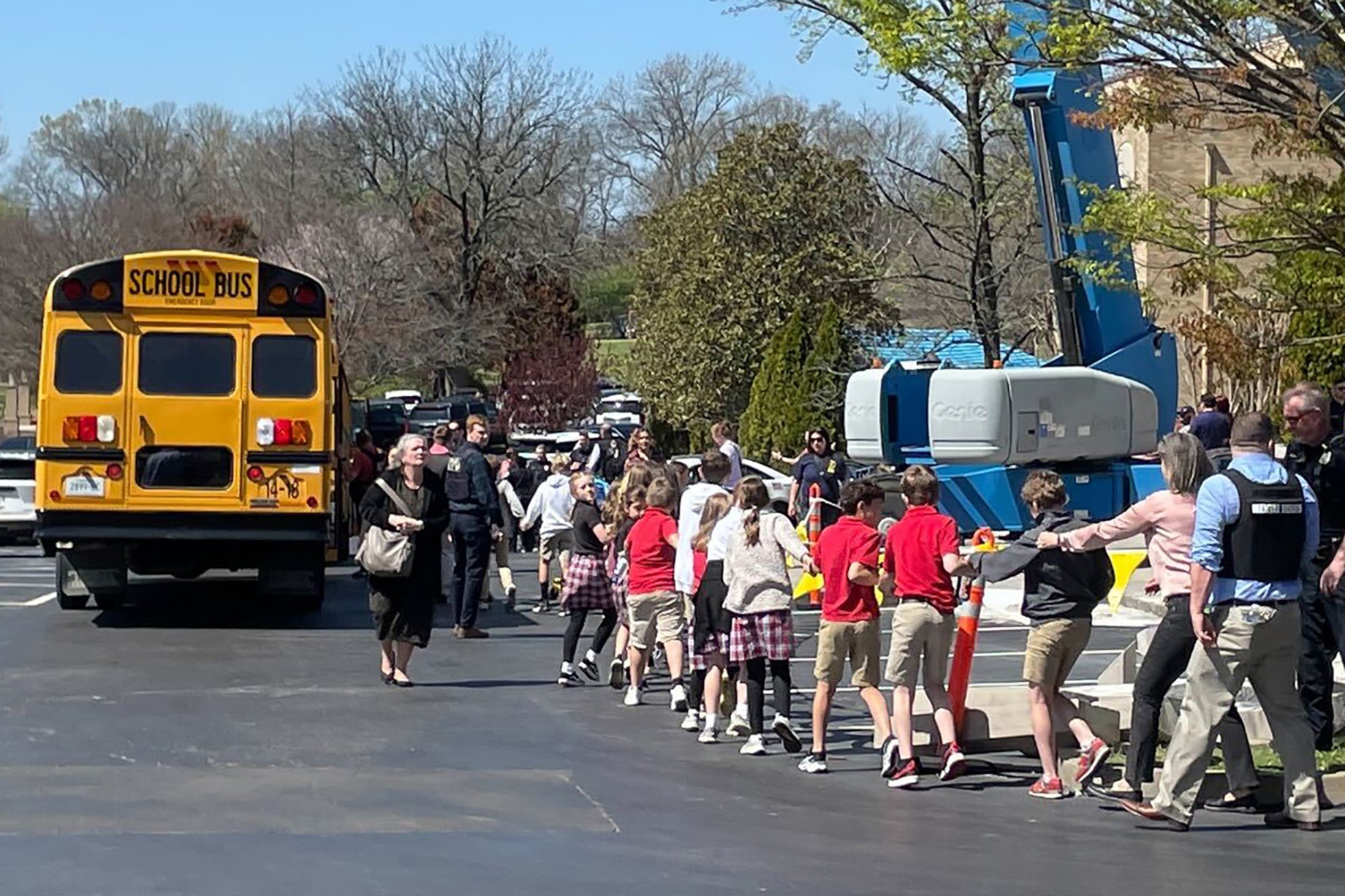 Children from The Covenant School hold hands as they leave the building&nbsp;on March 27.