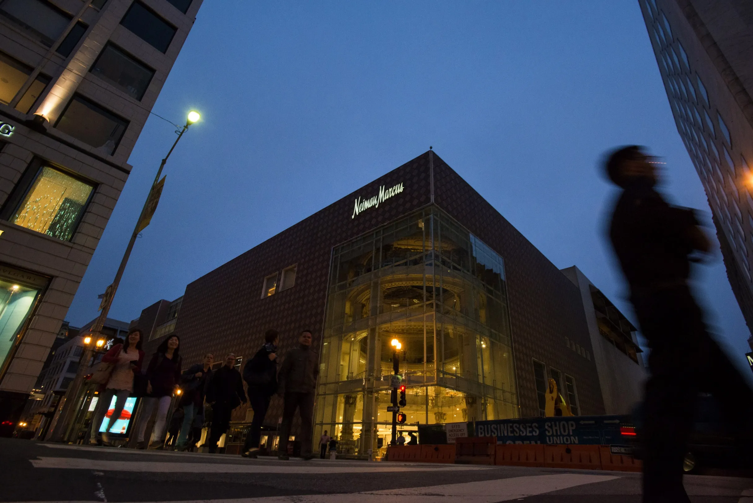 Pedestrians walk past a Neiman Marcus Inc. store in San Francisco, California, U.S., on Tuesday, July 2, 2013.