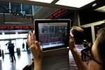 The stock price ticker screen is filmed following the reopening of the Athens Stock Exchange in Athens, on Aug. 3, 2015.
