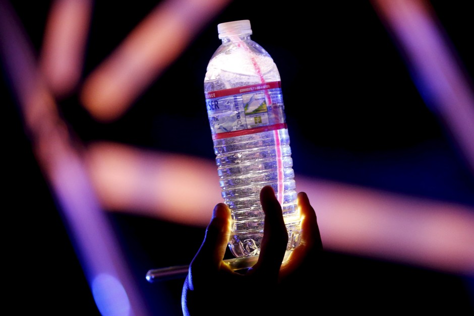 A person carries a bottle of Crystal Geyser spring water, which is bottled in California, at the Coachella Valley Music and Arts Festival in Indio, California.