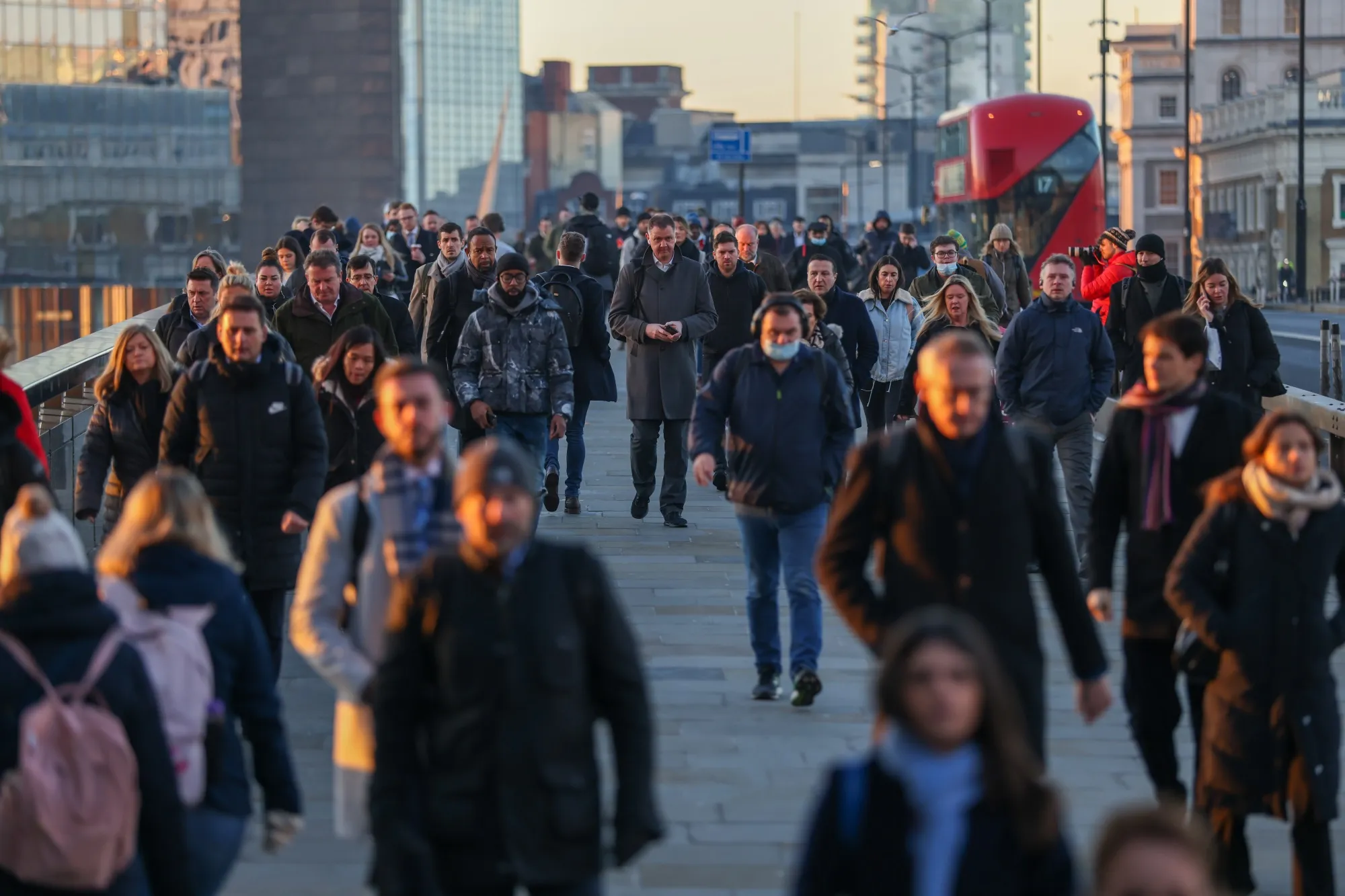 Morning commuters on London Bridge head towards the City of London, U.K.