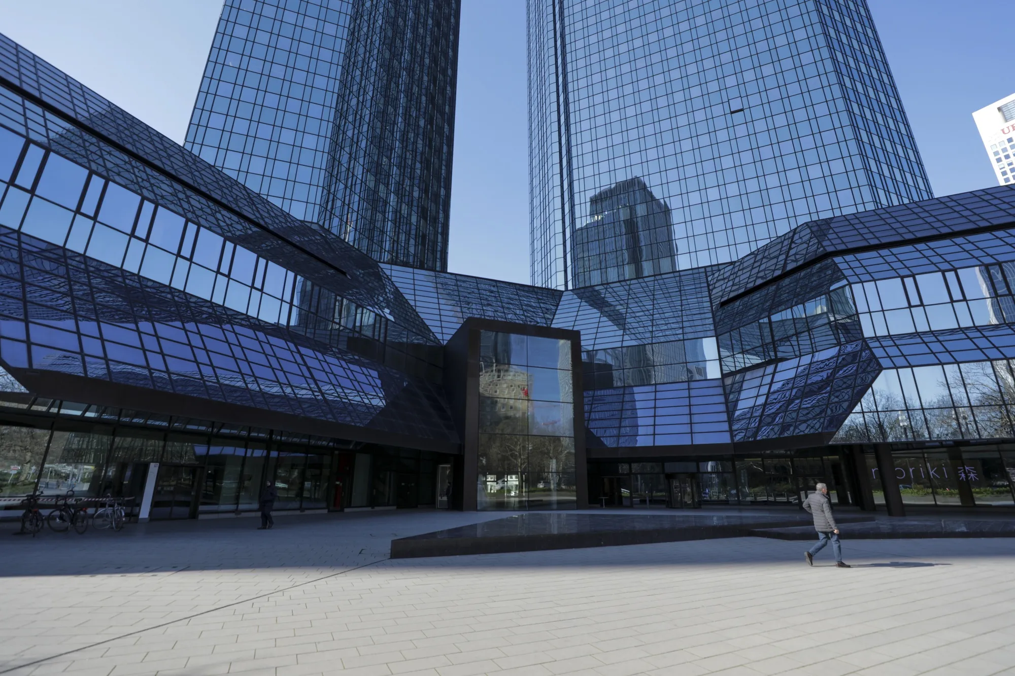 A pedestrian passes the Deutsche Bank AG headquarters&nbsp;in Frankfurt.