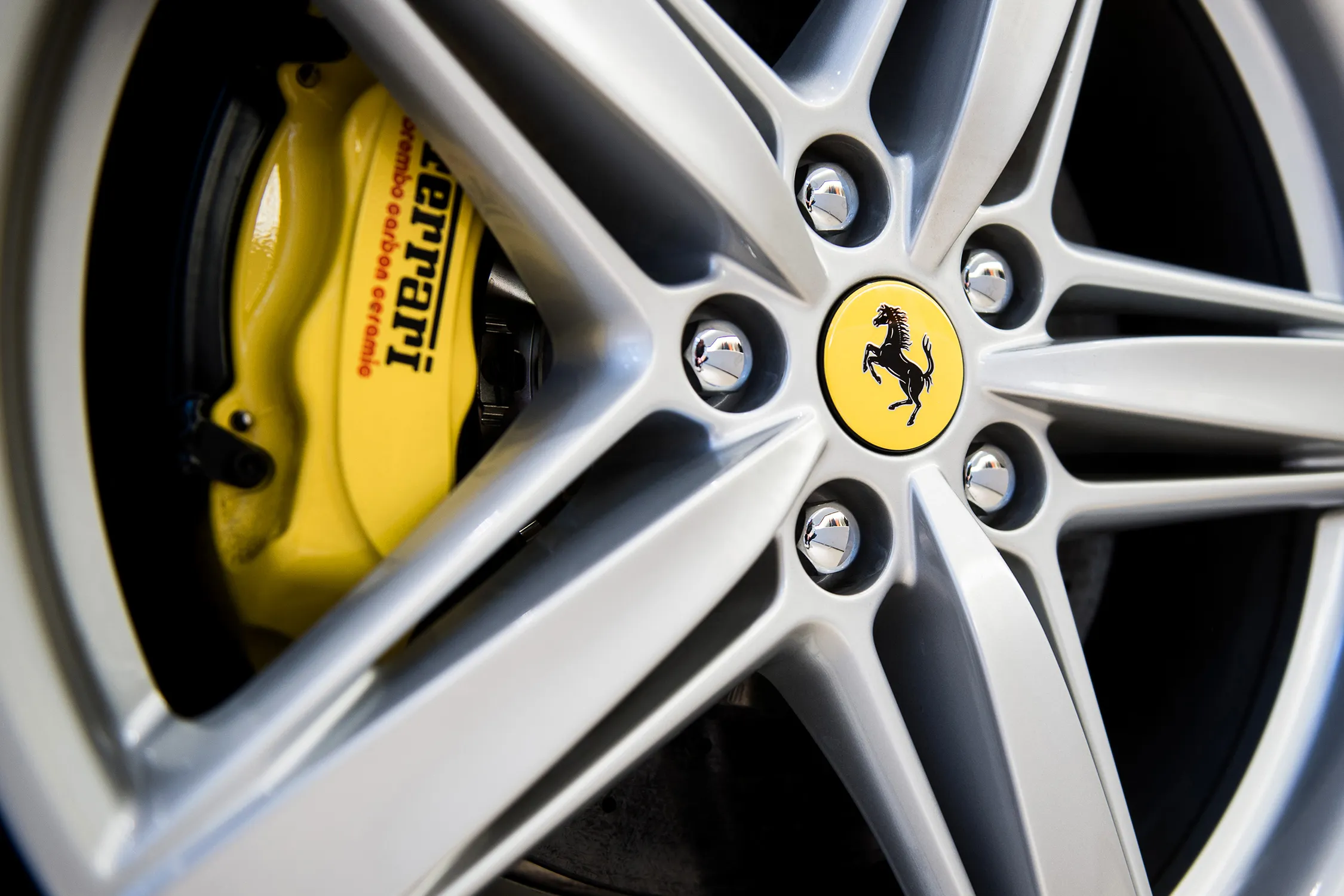 The prancing horse logo sits on the wheel hub of a Ferrari F12 Berlinetta luxury automobile, produced by Ferrari SpA, inside a Ferrari SpA dealership in Budapest, Hungary, on Tuesday, Dec. 1, 2015. Ferrari, the supercar maker being spun off from Fiat Chrysler Automobiles NV, sees profit rising as much as 7.5 percent this year after reporting a 35 percent jump in the third quarter on higher sales of cars likes the California roadster.
