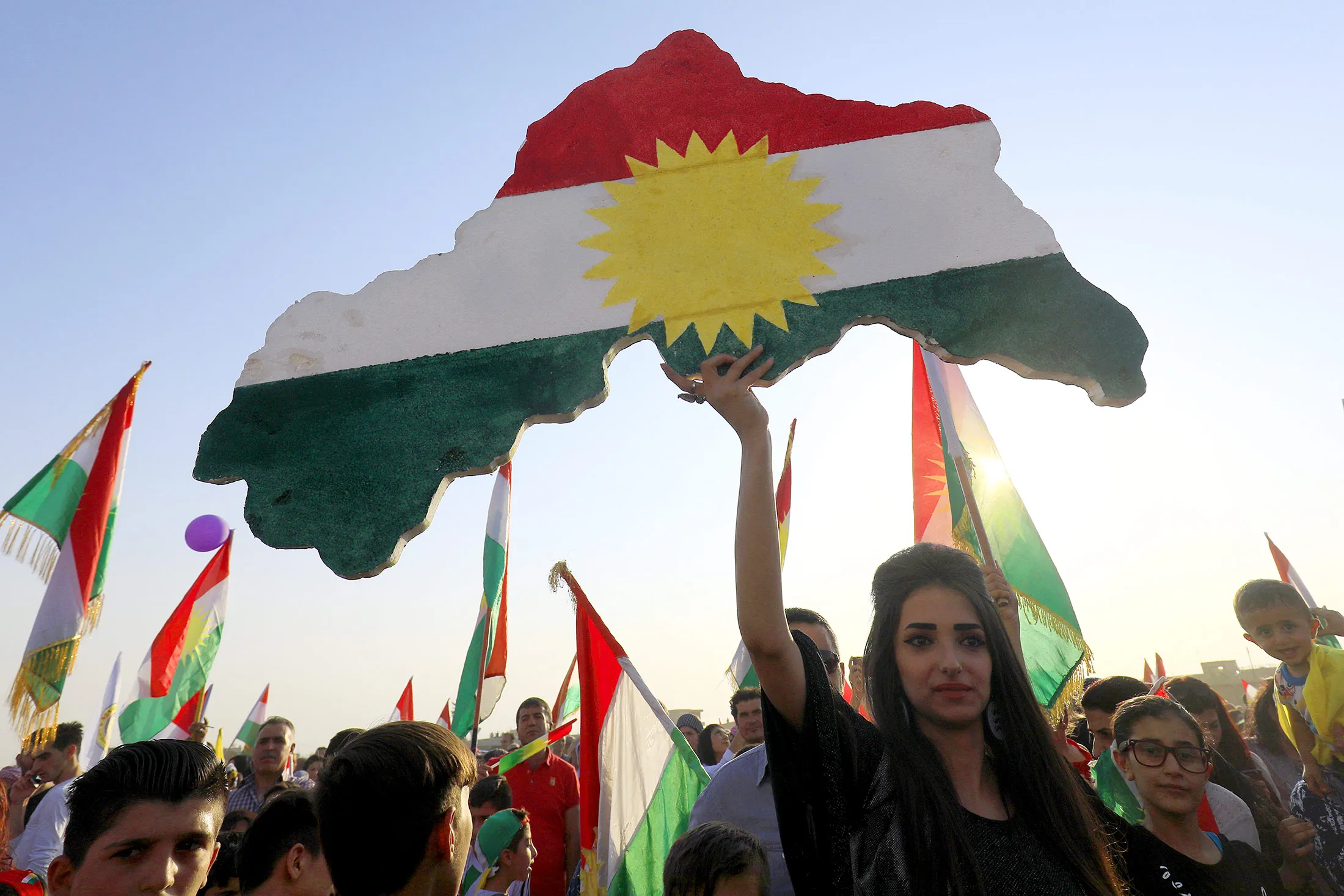 Syrian Kurds take part in a rally in the northeastern Syrian city of Qamishli in support of an independence referendum.
