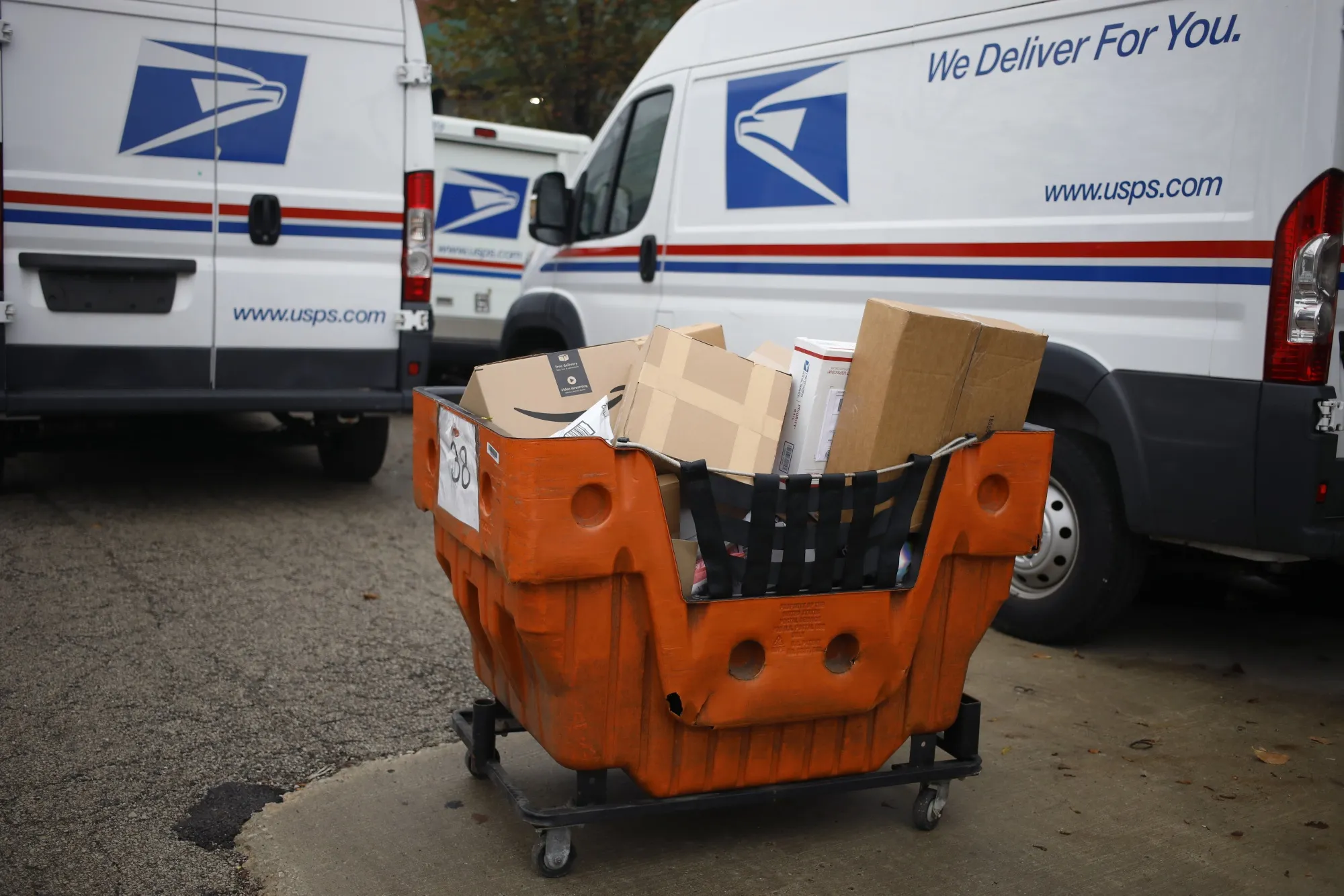 A cart of mail and packages outside a United States Postal Service&nbsp;distribution center.
