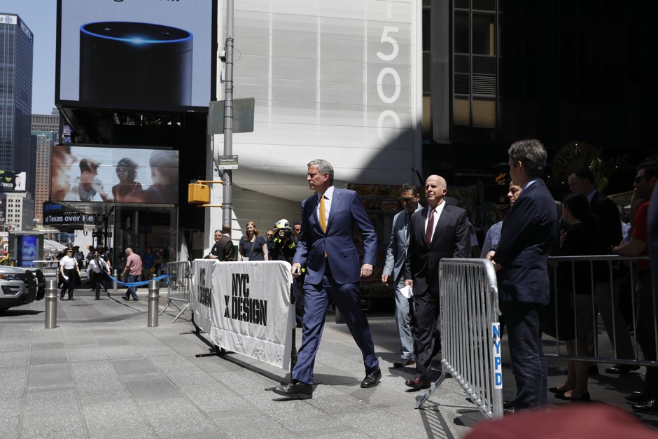 New York City Mayor Bill de Blasio walks with other officials in May.