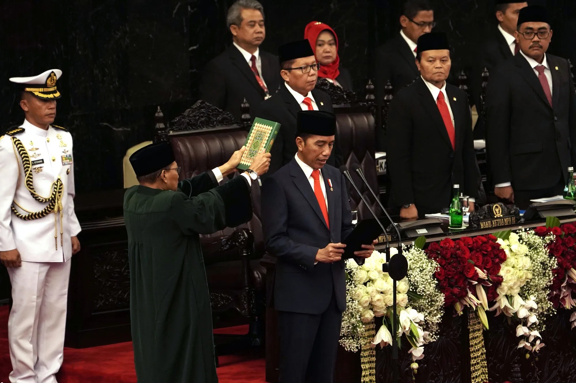 Joko Widodo recites the oath of office next to the Holy Quran on Oct. 20.
