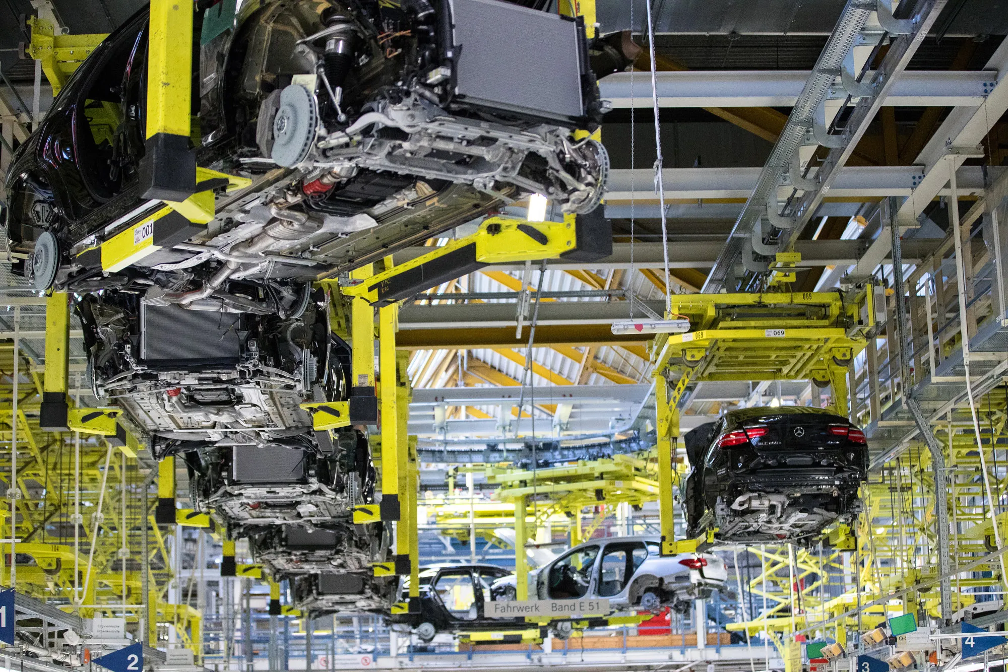 Mercedes-Benz C-Class automobiles and GLC sports utility vehicles&nbsp;are transported in cradles on the assembly line at the&nbsp;automaker's factory in Bremen, Germany.