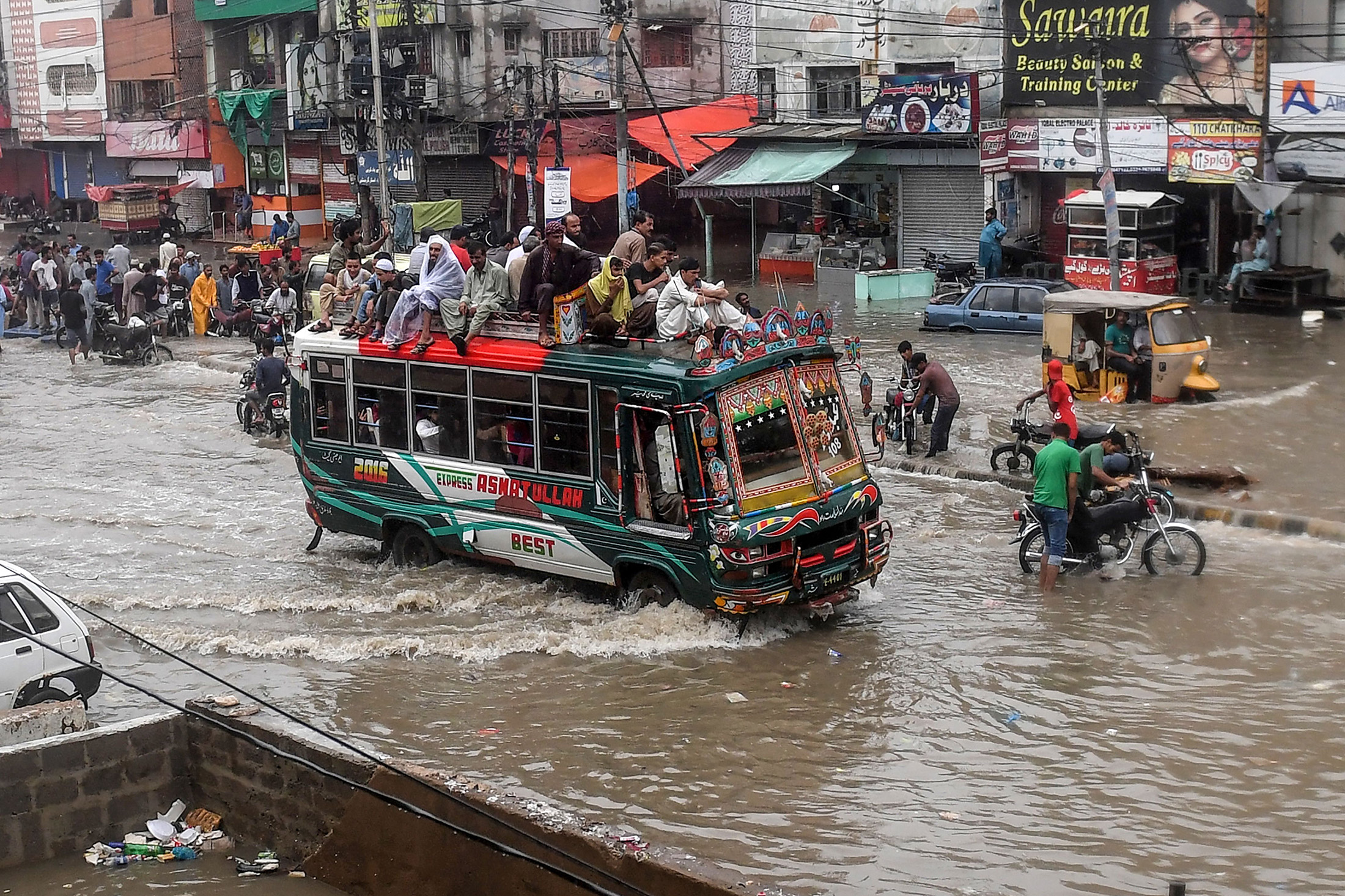 Vehicles wade through a flooded street after heavy monsoon rains in Karachi on Aug. 27.