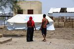 Ethiopian soldiers head to a tent at the Um Gargour refugee camp in eastern Sudan where they have found interim sanctuary, on May 23.