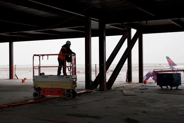 A construction worker stands on a lift during works in terminal 4 at John F. Kennedy International Airport in New York