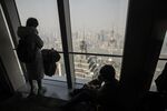 People look at the view from the observation deck at the Shanghai World Financial Center.