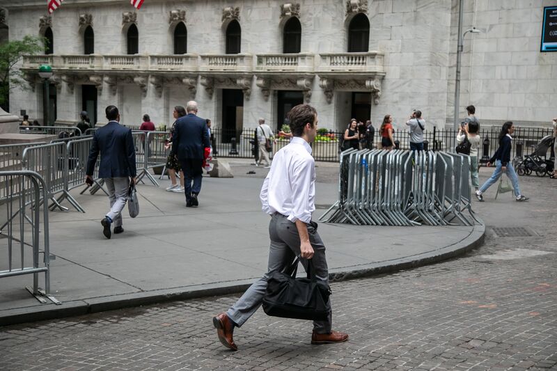 Pedestrians in front of the New York Stock Exchange (NYSE) in New York, US