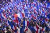 Supporters with French national flags during a National Rally event in Paris. 