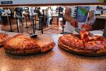 A student grabs a slice of pizza at the Clark Kerr dining hall on the University of California at Berkeley campus in Berkeley, California.